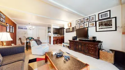a living room with a couch and a tv at Summit 45 Apartment in Mammoth Lakes