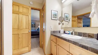 a bathroom with a sink and a mirror at Summit 55 Apartment in Mammoth Lakes