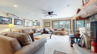a living room with a couch and a fireplace at Summit 81 Apartment in Mammoth Lakes