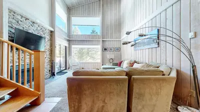 a living room with two couches and a tv at Mammoth Reservations in Mammoth Lakes