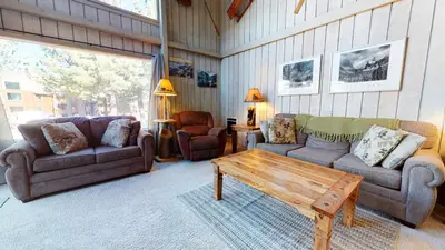 a living room with couches and a coffee table at Summit 110 Apartment in Mammoth Lakes