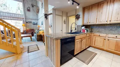 a kitchen with a sink and a dishwasher at Summit 110 Apartment in Mammoth Lakes