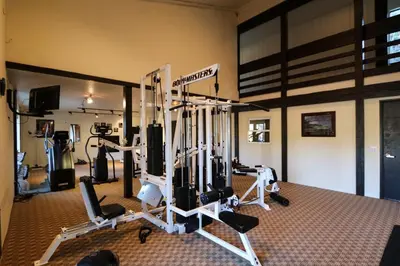 a gym with several tread machines in a room at Summit 211 Apartment in Mammoth Lakes