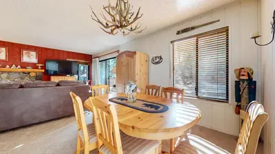 a dining room with a wooden table and chairs at Rustic Summit 237 On Free Shuttle Route in Mammoth Lakes