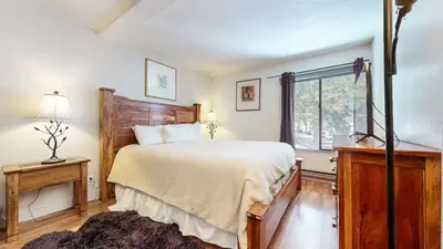 a bedroom with a large bed and a window at Mammoth Reservations in Mammoth Lakes
