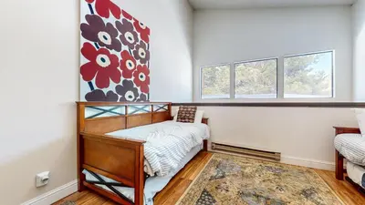a bedroom with a bed and two windows at Mammoth Reservations in Mammoth Lakes