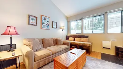 a living room with a couch and a table at Mammoth Reservations in Mammoth Lakes