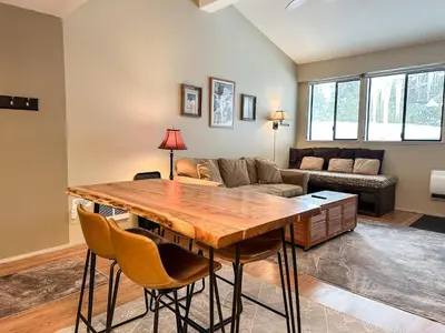 a living room with a wooden table and chairs at Mammoth Reservations in Mammoth Lakes