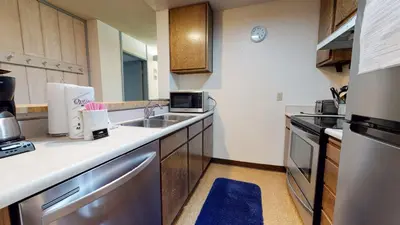 a small kitchen with a sink and a stove at Mammoth Reservations in Mammoth Lakes