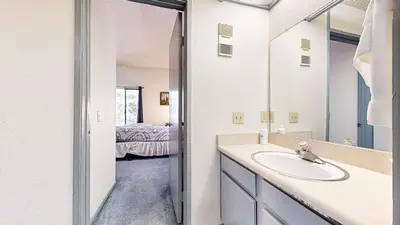 a bathroom with a sink and a mirror at Mammoth Reservations in Mammoth Lakes