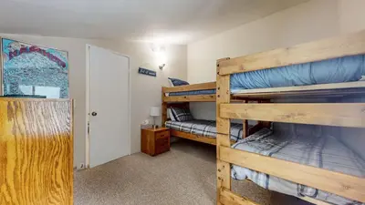 a bedroom with two bunk beds in a room at Mammoth Reservations in Mammoth Lakes