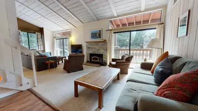 a living room with a couch and a table at Mammoth Reservations in Mammoth Lakes