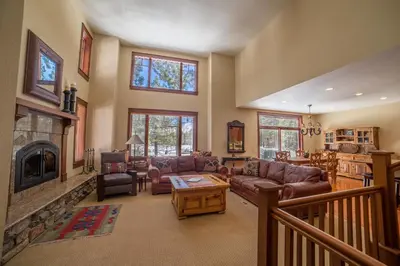 a living room with a couch and a fireplace at Timbers 1 Apartment in Mammoth Lakes