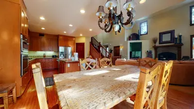 a kitchen and dining room with a wooden table in a room at Timbers 1 Apartment in Mammoth Lakes