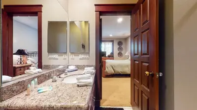 a bathroom with a sink and a large mirror at Timbers 1 Apartment in Mammoth Lakes