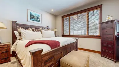 a bedroom with a large bed and a window at Timbers 18 Apartment in Mammoth Lakes