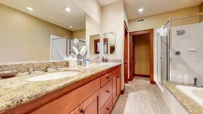 a bathroom with two sinks and a shower at Timbers 18 Apartment in Mammoth Lakes