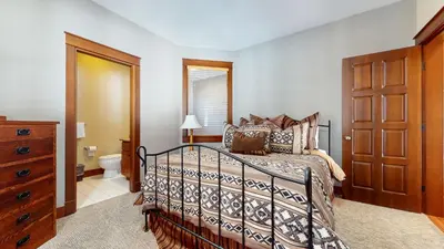 a bedroom with a bed and a dresser at Timbers 18 Apartment in Mammoth Lakes