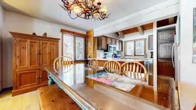 a dining room with a glass table and chairs at Wild Flower 6 Apartment in Mammoth Lakes