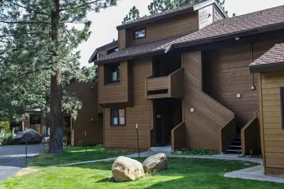a house with two rocks in front of it at Wild Flower 6 Apartment in Mammoth Lakes