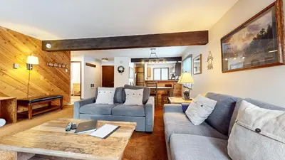a living room with a couch and a table at Wild Flower 37 Apartment in Mammoth Lakes