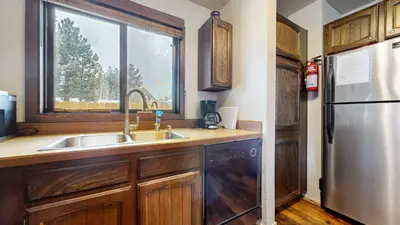 a kitchen with a sink and a refrigerator at Wild Flower 39 Apartment in Mammoth Lakes