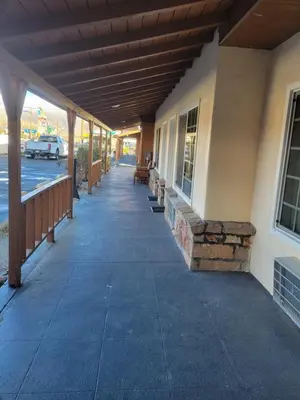 a porch of a building with awning and benches at Townhouse Motel in Bishop