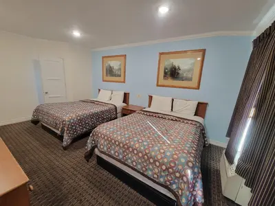 a hotel room with two beds and a television at Townhouse Motel in Bishop