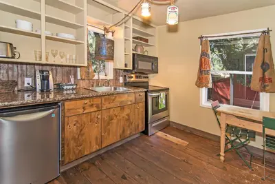 a kitchen with wooden cabinets and a wooden table at Miner's Camp in Foresthill