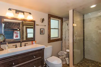 a bathroom with a toilet and a sink and a shower at Miner's Camp in Foresthill