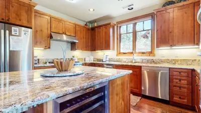 a kitchen with wooden cabinets and a granite counter top at Gray Stone 2088 Holiday home in Mammoth Lakes