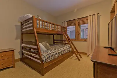 a bedroom with a bunk bed and a desk at Stonegate 5 Holiday home in Mammoth Lakes