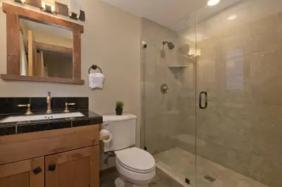 a bathroom with a shower and a toilet and a sink at Stonegate 5 Holiday home in Mammoth Lakes