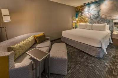 a hotel room with a bed and a couch at Courtyard by Marriott Reno Downtown/Riverfront in Reno