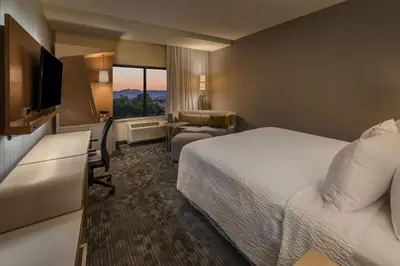 a hotel room with a bed and a television at Courtyard by Marriott Reno Downtown/Riverfront in Reno
