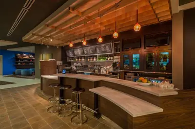 a large kitchen with a bar with stools at Courtyard by Marriott Reno Downtown/Riverfront in Reno