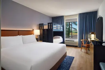 a hotel room with a bed and a desk and a bed at Martis Valley Lodge, Tapestry Collection by Hilton in Truckee