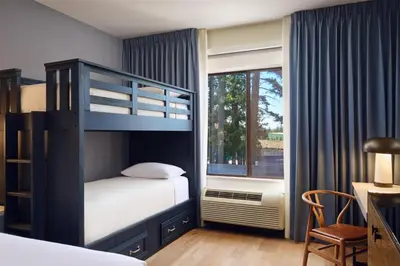 a bedroom with a bunk bed and a window at Martis Valley Lodge, Tapestry Collection by Hilton in Truckee