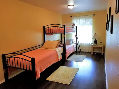 a bedroom with two bunk beds and a window at Charming Downstairs Unit in Oakhurst