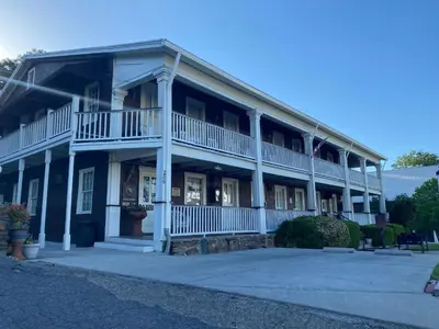 a large blue building with white columns and balconies at Gunn House Hotel in Sonora