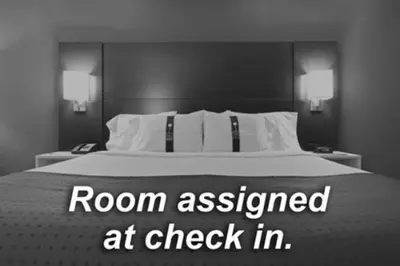 a bedroom with a bed with a room assessed at check in at Holiday Inn Express Reno Airport by IHG in Reno
