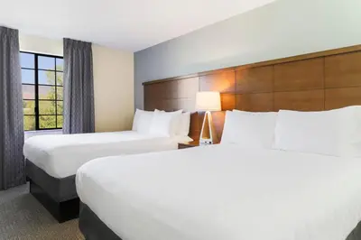 a hotel room with two beds and a window at Staybridge Suites Reno Nevada by IHG in Reno