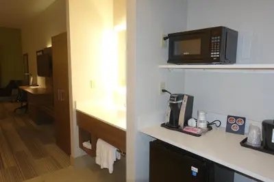a room with a kitchen with a microwave and a counter at Holiday Inn Express & Suites Brentwood in Brentwood