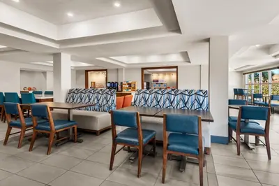 a dining room with a table and chairs at Holiday Inn Express Fresno River Park Highway 41 by IHG in Fresno