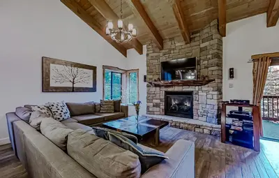 a living room with a couch and a fireplace at Village Treehouse #1 in Mammoth Lakes