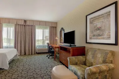a hotel room with a bed a desk and a television at Hilton Garden Inn Sacramento Elk Grove in Elk Grove