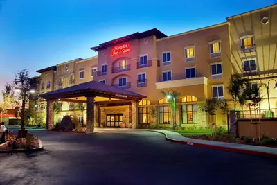 a hotel with a parking lot in front of it at Hampton Inn & Suites Lodi in Lodi