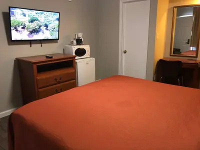 a bedroom with a bed and a tv on the wall at Alpine Inn & Spa in South Lake Tahoe