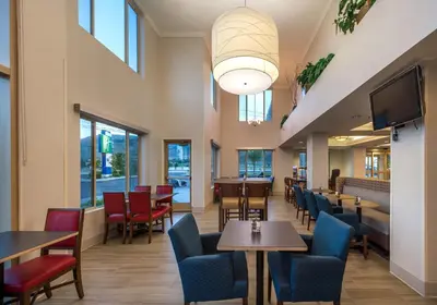 a restaurant with tables and chairs and a tv at Holiday Inn Express Hotel & Suites Carson City by IHG in Carson City