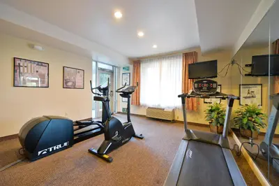 a gym with two treadmills and two exercise bikes at Holiday Inn Express Elk Grove West I-5 by IHG in Elk Grove